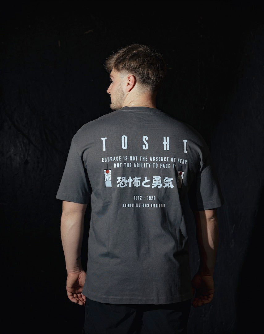 T-shirt oversize gris TOSHI “Fear and Courage” pour homme, inspiré de l’univers de Demon Slayer, style manga japonais et streetwear sportif.